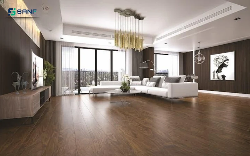 Phòng khách rộng lát sàn nhựa giả gỗ óc chó đậm với sofa trắng và cửa kính lớn đón sáng